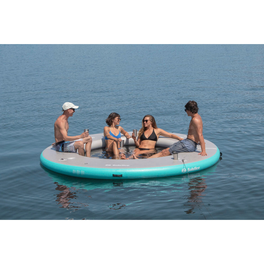 Solstice inflatable circular mesh dock with 4 people enjoying the dock and using the cup holders