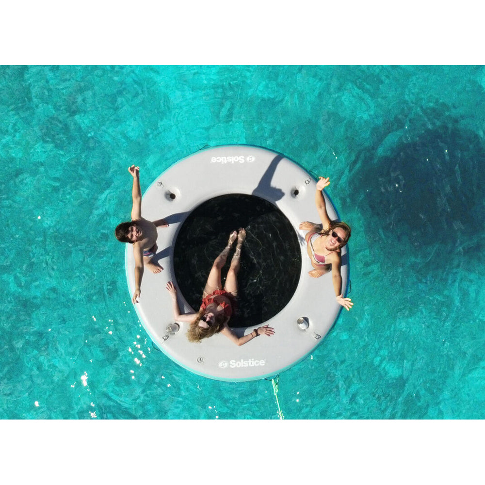 Solstice inflatable circular mesh dock with people standing and sitting on it