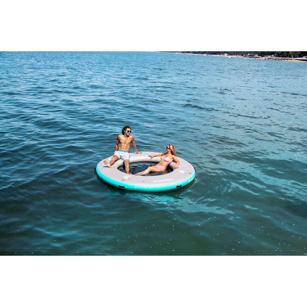 Solstice inflatable circular mesh dock with people sitting on it