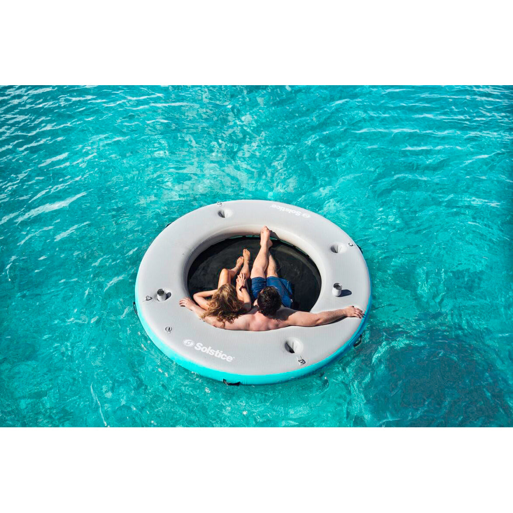 Solstice inflatable circular mesh dock with people sitting on it