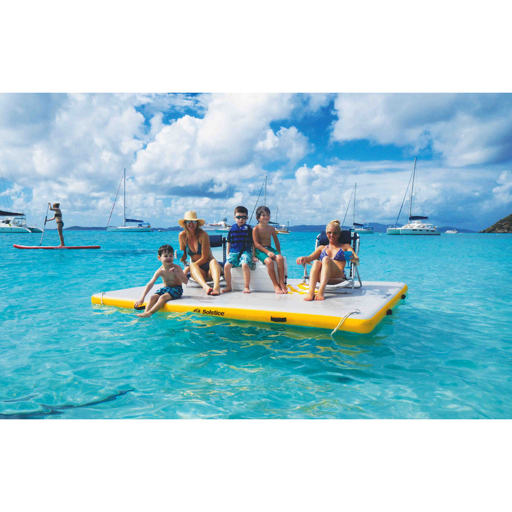 Solstice inflatable dock in the ocean with people sitting on it