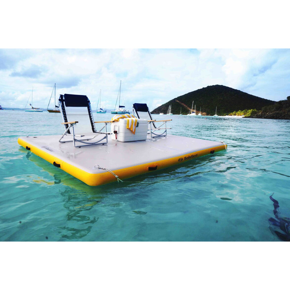 Solstice 10 foot by 8 foot inflatable dock holding beach chairs and cooler