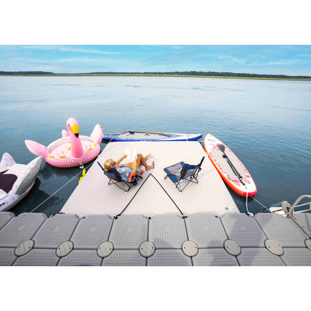 Solstice inflatable dock in use with floats and inflatable paddleboards tied to it