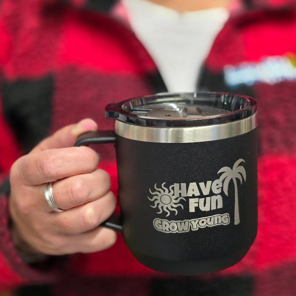 Have Fun Grow Young insulated coffee mug being held by a person