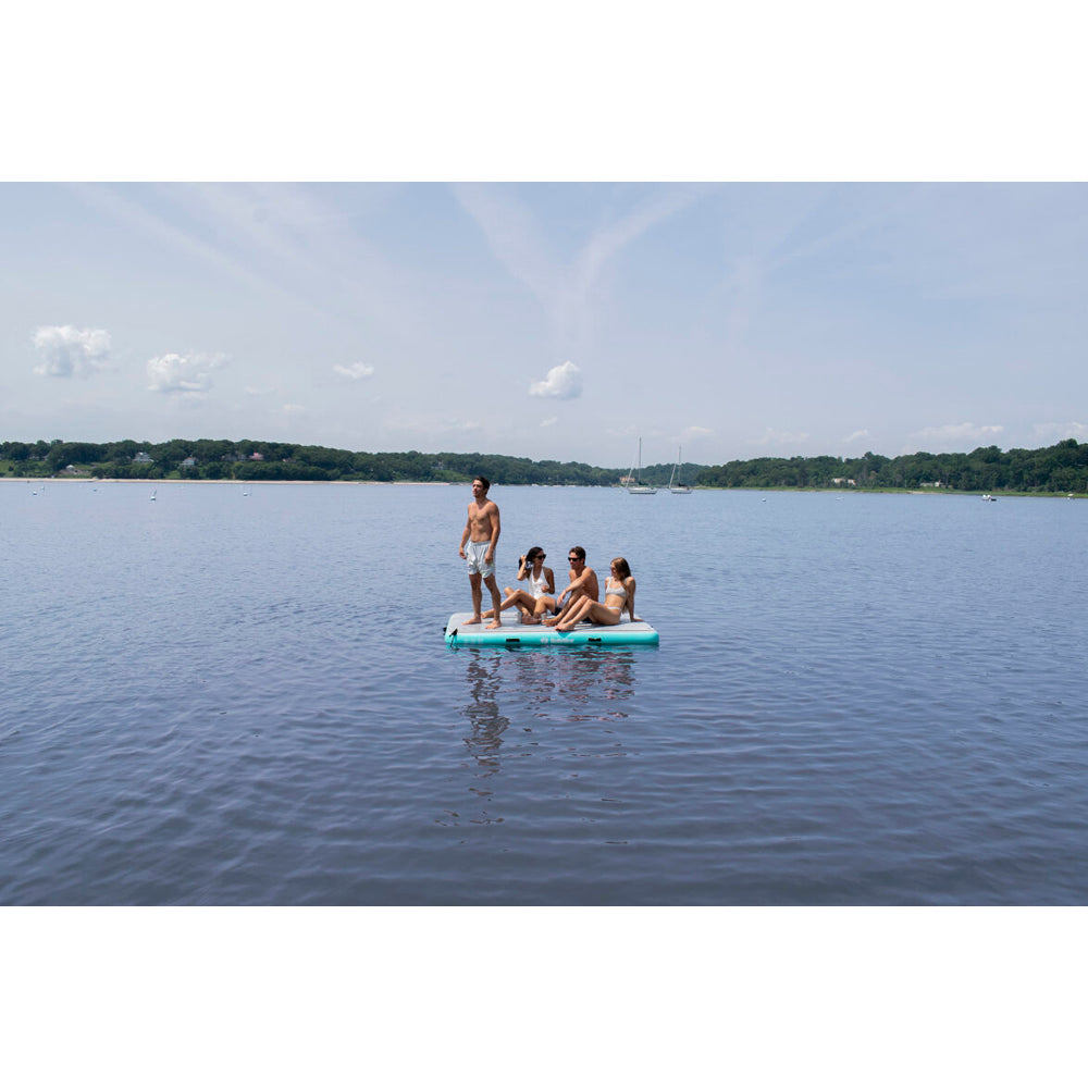 Solstice luxury inflatable dock with integrated traction pad, shown with 4 people on the dock