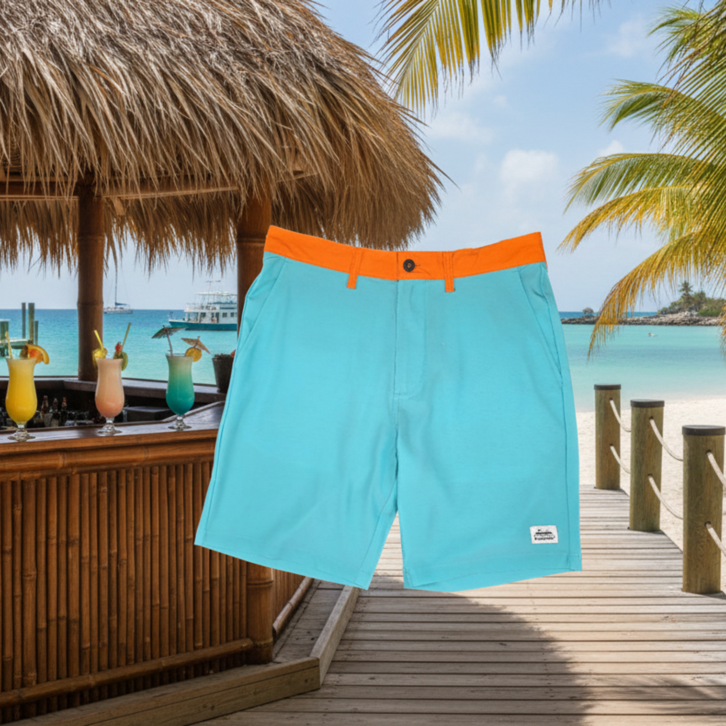 Docktails brand boardshorts aqua color with orange waistband, set against a tropical background