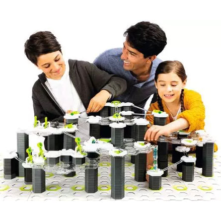 Family playing with GraviTrax Starter Set Marble Track Building System