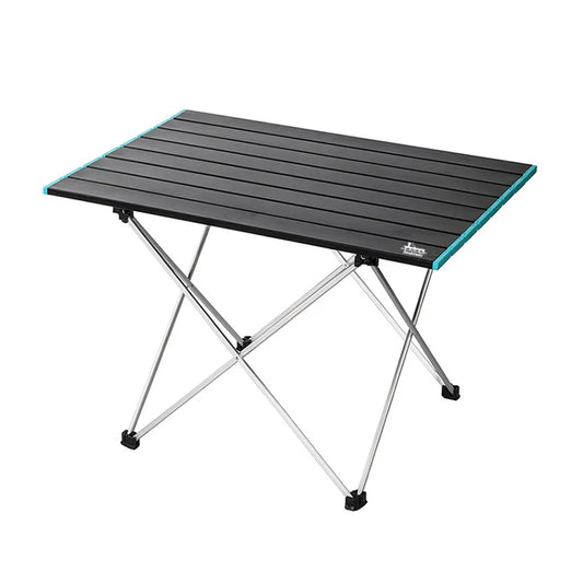 A portable folding camping table with a black slatted top and silver metal legs, featuring a small white brand logo on the bottom right corner of the tabletop.