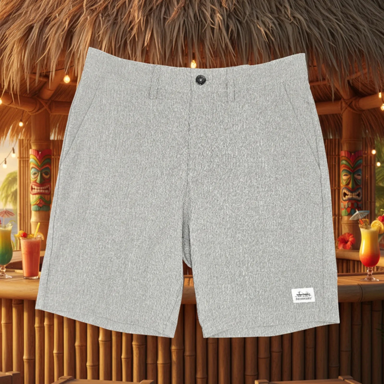 Light gray heathered shorts with a single button closure, displayed against a tropical beach bar background with tiki decor and drinks.