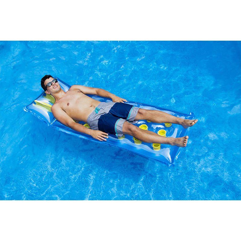Man lounging on 18 pocket inflatable pool mattress from Solstice Swimline